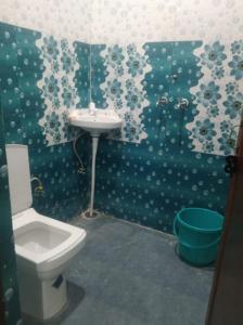 a bathroom with a toilet and a sink at Jolly Hill Stay in Doiwāla