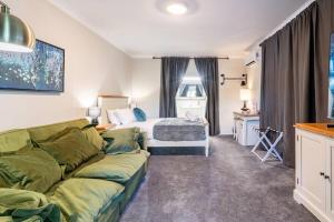 un soggiorno con divano e letto di Cypress BnB a Hervey Bay