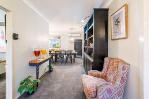 a living room with two chairs and a table at Cypress BnB in Hervey Bay