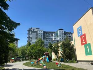 a playground in a park with a building in the background at 2-х комнатная квартира #Inamstro Apartament cu 2 camere cu TERASA in Chişinău
