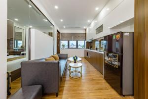 a kitchen and living room with a couch and a table at Phong Lan Apartments in Hai Phong