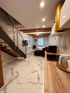 a living room with a marble floor and a staircase at Appartement au centre du Port de Bonifacio in Bonifacio +28 photos