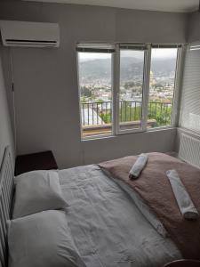 a bedroom with a large bed with two pillows on it at Roofs Tbilisi wine & rooms in Tbilisi City