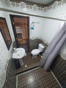 a bathroom with a sink and a toilet at Rasul-Nazar in Khiva