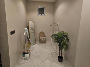 a bathroom with a shower and a potted plant at استديو انيق وراقي in Riyadh