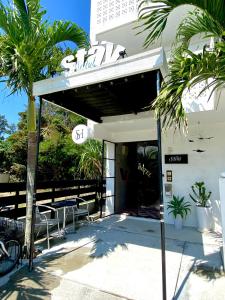 a gas station with tables and chairs in front of it at Stäy Hotel in Nago