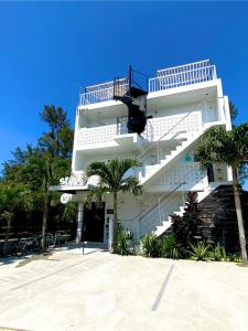 a white building with stairs on the side of it at Stäy Hotel in Nago