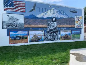 a mural on the side of a building with pictures on it at The Lodge Tulelake in Tulelake