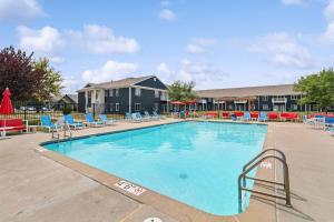 a large swimming pool with chairs and tables at Welcoming 4BR near ISU in Ames