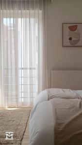 Een bed of bedden in een kamer bij Suite Maritim - Zijdelings zeezicht op 50m van strand en zee