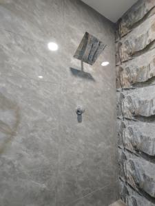 a bathroom with a shower with a stone wall at 232 Permai Duyung Family Gathering in Seremban