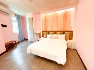Postel nebo postele na pokoji v ubytování 綠島海灣會館Bay Resort