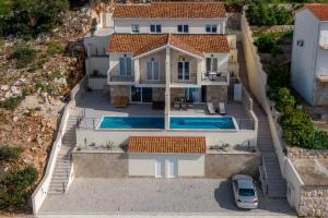 an aerial view of a house with a swimming pool at BohoSol House in Blato
