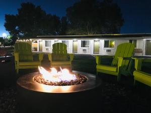 a fire pit in front of a rv at night at Dragonfly Motor Lodge in Panguitch