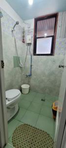 a bathroom with a shower and a toilet at Home Sweetie Homestay & Bunkbeds in Moalboal +12 photos