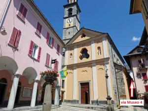 un edificio con una torre dell'orologio in cima di Casa Chiara a Intragna (Centovalli)