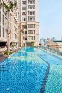 ホーチミン・シティにあるDOUBLE N Apartment - 3 Bedrooms in Central of Saigon - Free Pool, Gym - Riverside Viewの建物前の青い大型スイミングプール