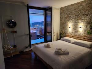 a bedroom with a large bed and a large window at Attico 26 in Perugia