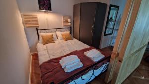 a bedroom with a bed with towels on it at Luna in Osijek
