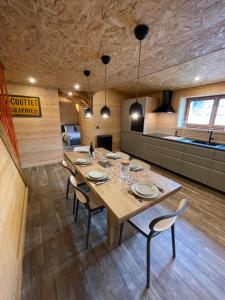 a dining room with a large wooden table and chairs at Chalet Atmosphere Chamonix City Center Large T3 in Chamonix-Mont-Blanc