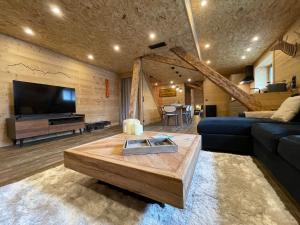 a living room with a couch and a coffee table at Chalet Atmosphere Chamonix City Center Large T3 in Chamonix-Mont-Blanc
