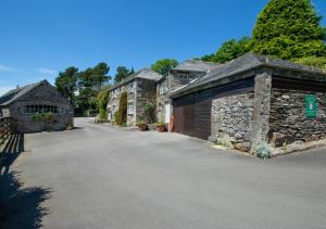 a row of stone buildings with a driveway at Otterbridge in Saint Breward