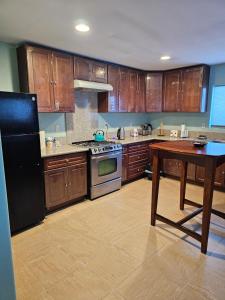 a large kitchen with wooden cabinets and a table at 5821 Gowdy lane bakersfield Ca 93307 in Bakersfield
