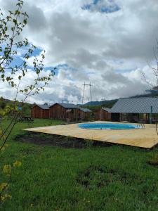 a swimming pool with a wooden deck in a field at MATEVOSYAN`S Rest House in Lermontovo