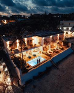 an aerial view of a building with a pool at night at Imara Beach Resort in Kiwengwa