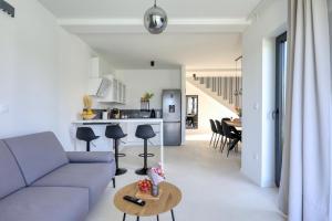 a living room with a couch and a table at Villa Cvit Mediterana with heated pool in Knežević