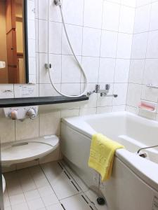 a bathroom with a tub and a toilet and a sink at Hashima - Hotel - Vacation STAY 51161v in Hashima +5 photos