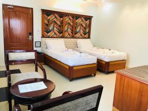 A bed or beds in a room at Naveed Residency