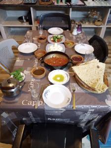 a table with plates of food on it at Bait Al-Bustan Umm Qais in Um Qeis