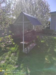 a gazebo with a roof in a yard at Your House in Karakol