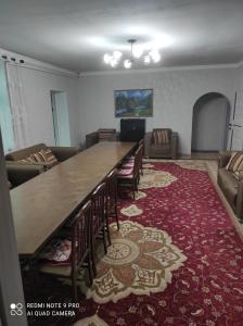 a large dining room with a large table and chairs at Your House in Karakol