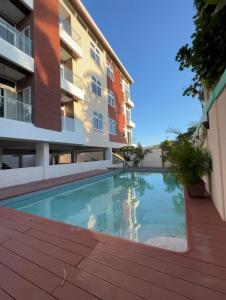 a swimming pool in front of a building at Luxury 2 bed Apartment in Kingston in Kingston
