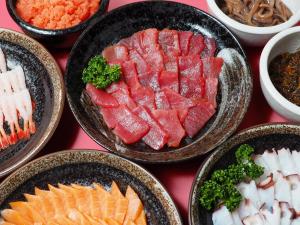 a table topped with bowls of different types of food at APA Hotel Sapporo Susukino Ekimae in Sapporo