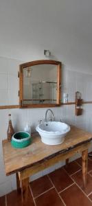 a bathroom with a sink and a mirror on a table at Dom na Mazurach Pilec- Apartament in Pilec