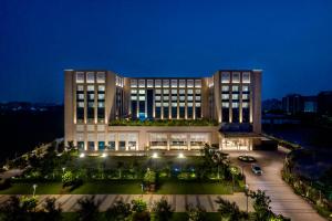 a large building with lights in front of it at night at Grand Madurai by GRT Hotels in Madurai