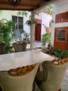 a white table and chairs in a yard at La Luna Boutique Dhangethi in Dhangethi