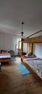 a bedroom with two bunk beds and a window at Dom na Mazurach Pilec- Apartament in Pilec