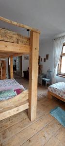 a bedroom with a large wooden bunk bed at Dom na Mazurach Pilec- Apartament in Pilec +52 photos