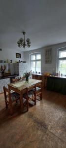 a kitchen with a wooden table in a room at Dom na Mazurach Pilec- Apartament in Pilec +52 photos