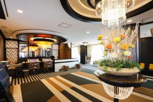 a lobby with a vase of flowers on a table at APA Hotel Sapporo Susukino Ekimae in Sapporo