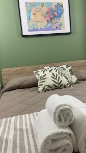 ein Bett mit einem Stapel Handtücher darüber in der Unterkunft MoMa B&B in Corigliano Calabro