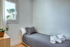 a bed in a small room with a window at Apartamento de lujo con vistas al mar, a dos minutos de la playa in Calella de Palafrugell