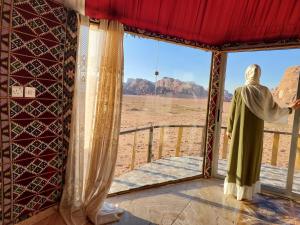 a statue looking out of a window at the desert at Joy to Wadi Rum in Wadi Rum