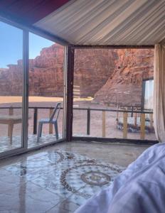 a bedroom with a view of the grand canyon at Joy to Wadi Rum in Wadi Rum