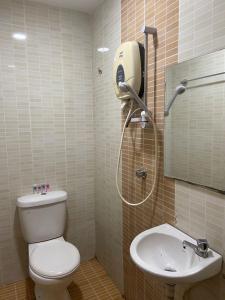 a bathroom with a shower and a toilet and a sink at HOTEL SAHARA SDN BHD in Rawang