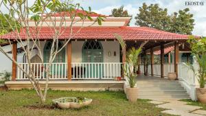 a house with a red roof and a porch at EKOSTAY - Blue Tiffany Villa in Nerul